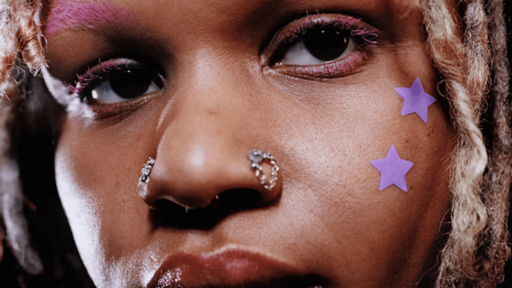 An image of a woman with star-shaped pimple patches