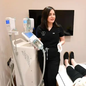An aesthetician operating a machine