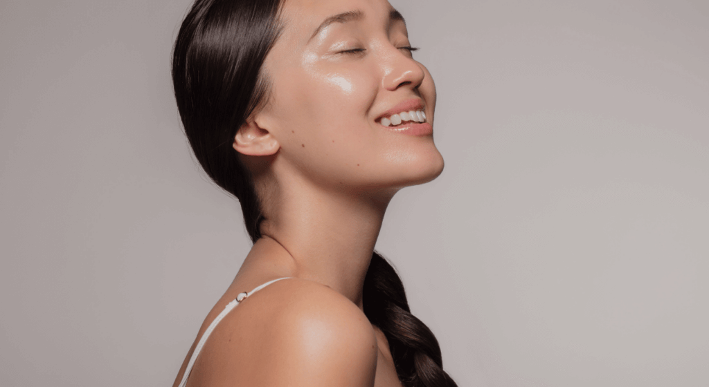 An image of a woman with beautiful skin smiling for an article about polynucleotides